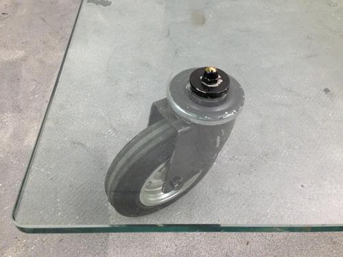 Low glass coffee table on industrial wheels