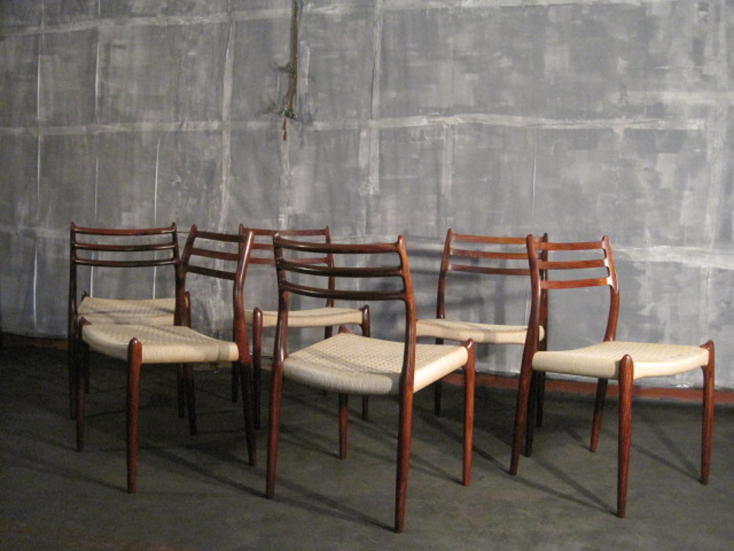 Six rosewood and cord chairs by Niels Moller