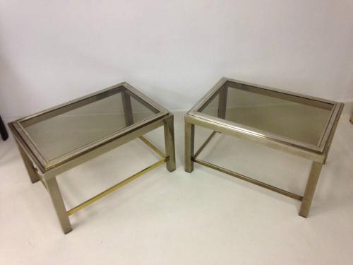 A pair of two tier chrome side tables