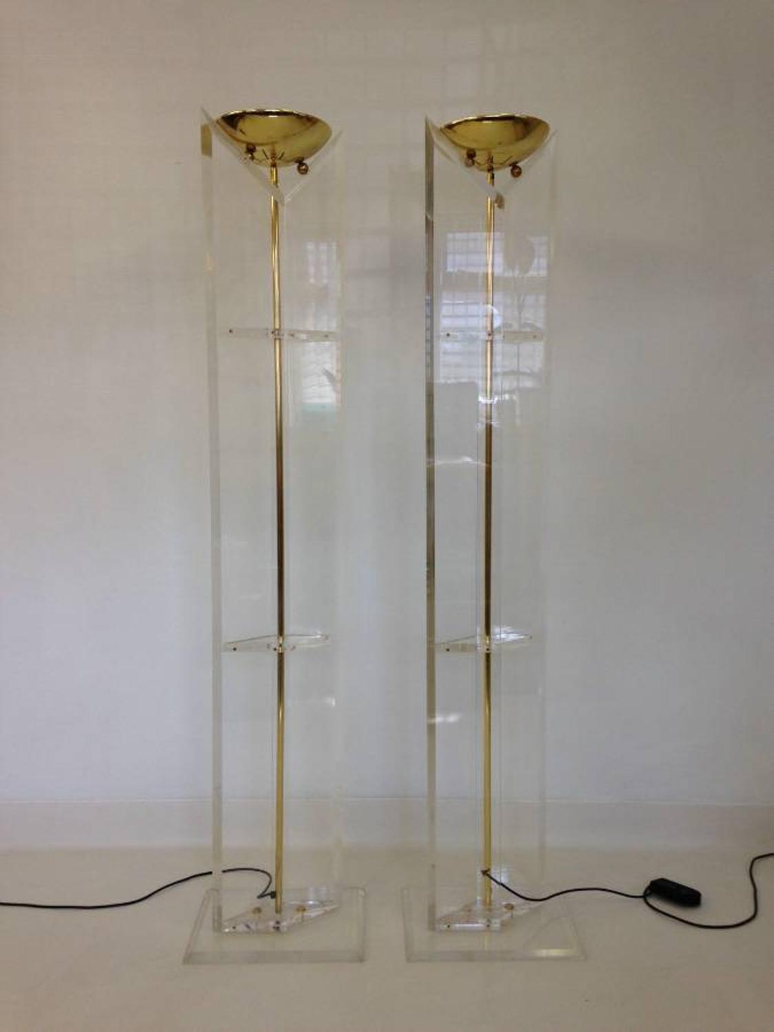 A pair of lucite and brass floor lamps