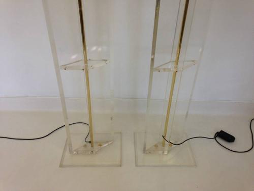 A pair of lucite and brass floor lamps