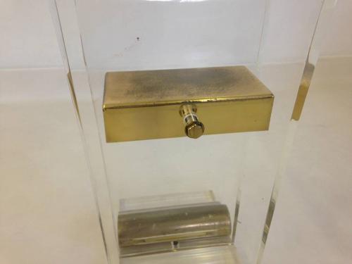 A pair of lucite and brass console tables