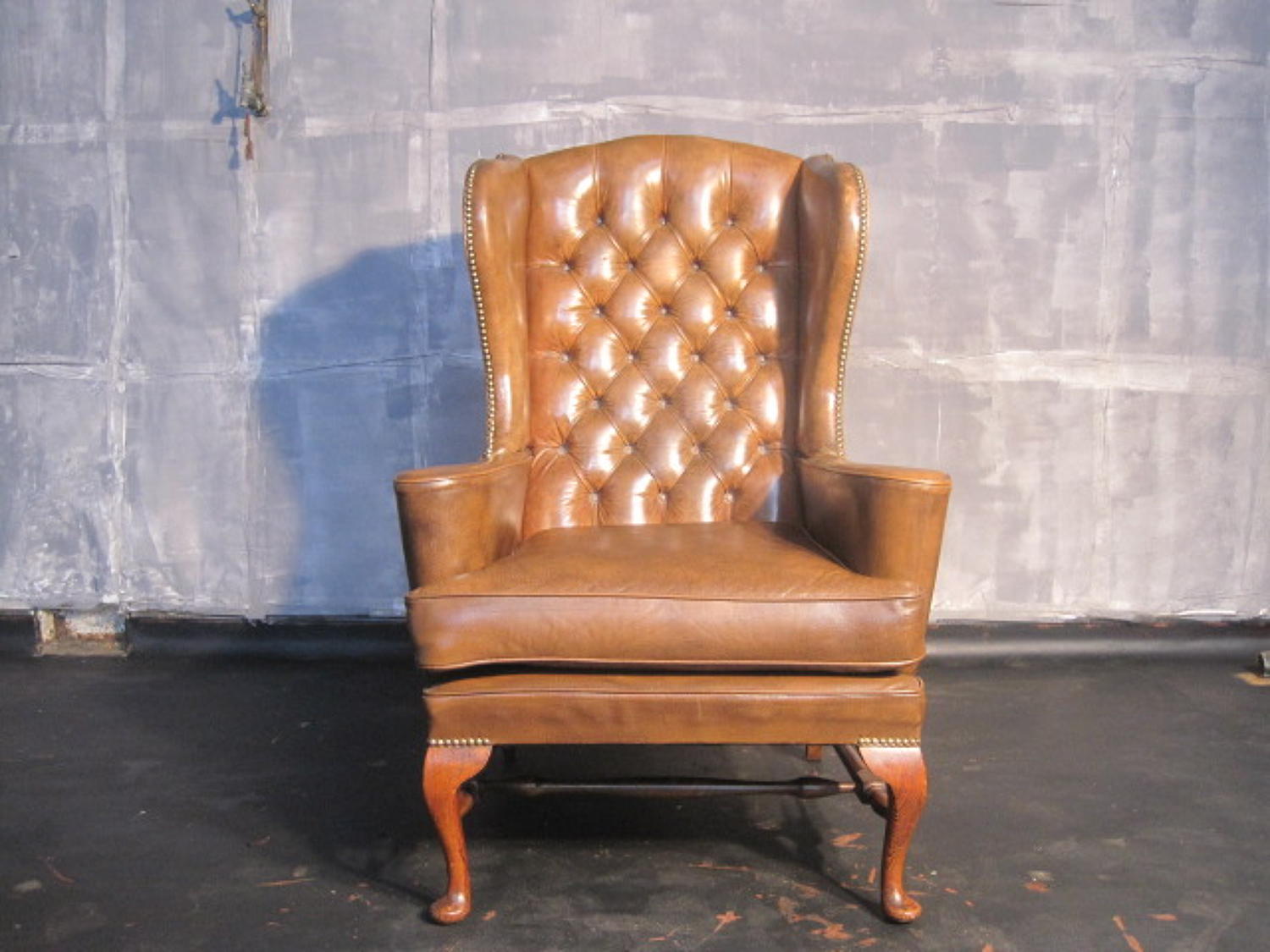 Brown leather wingback armchair