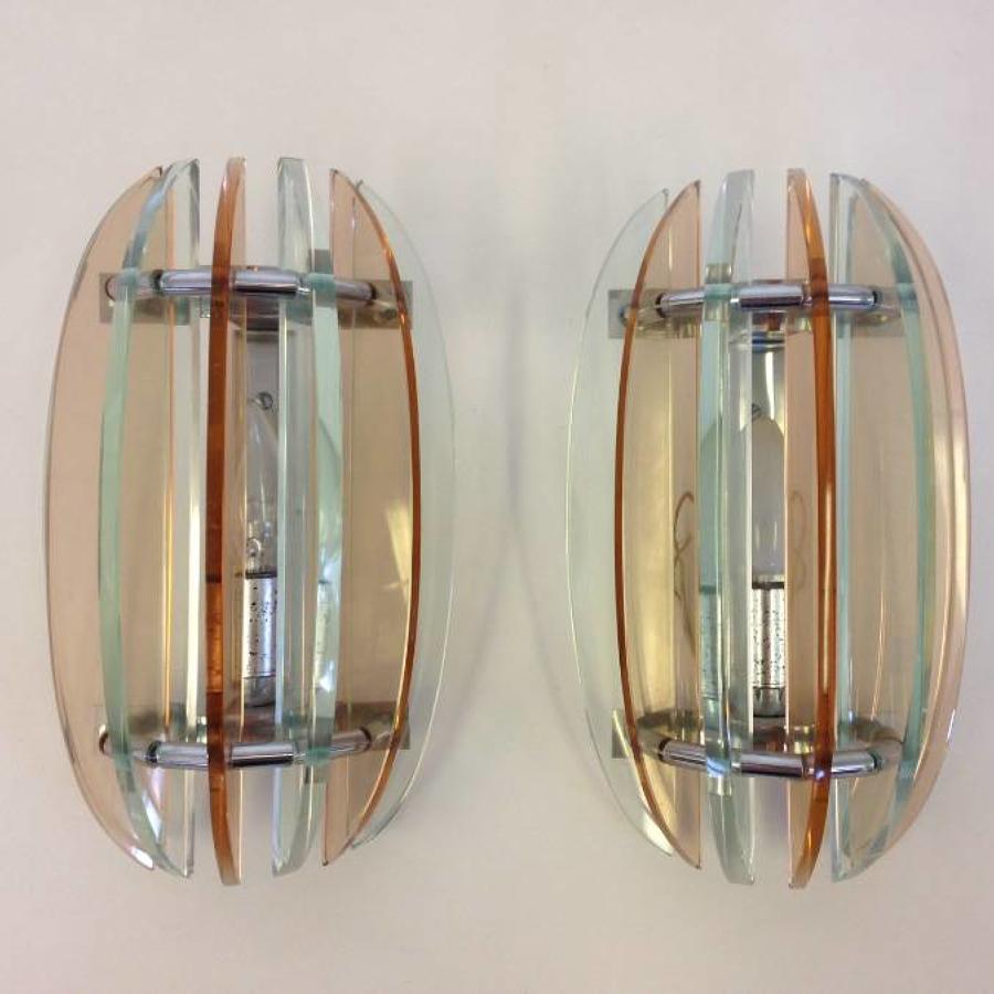 A pair of coloured glass wall lights
