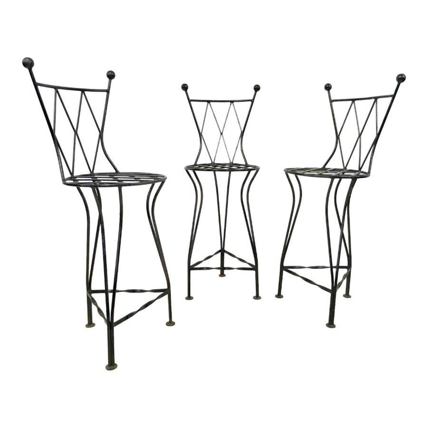 A set of three iron bar stools