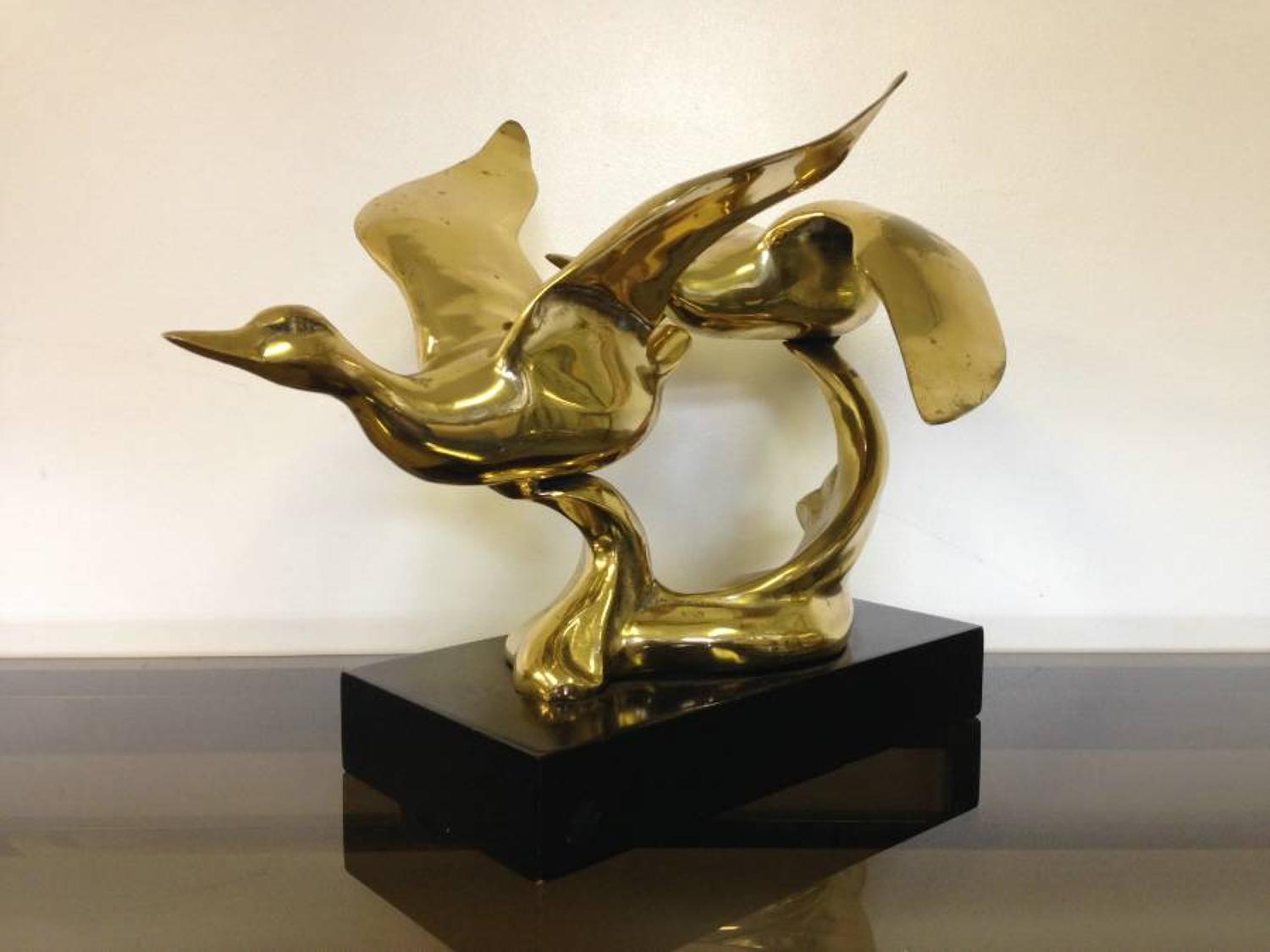 Brass swans on lacquered wood base