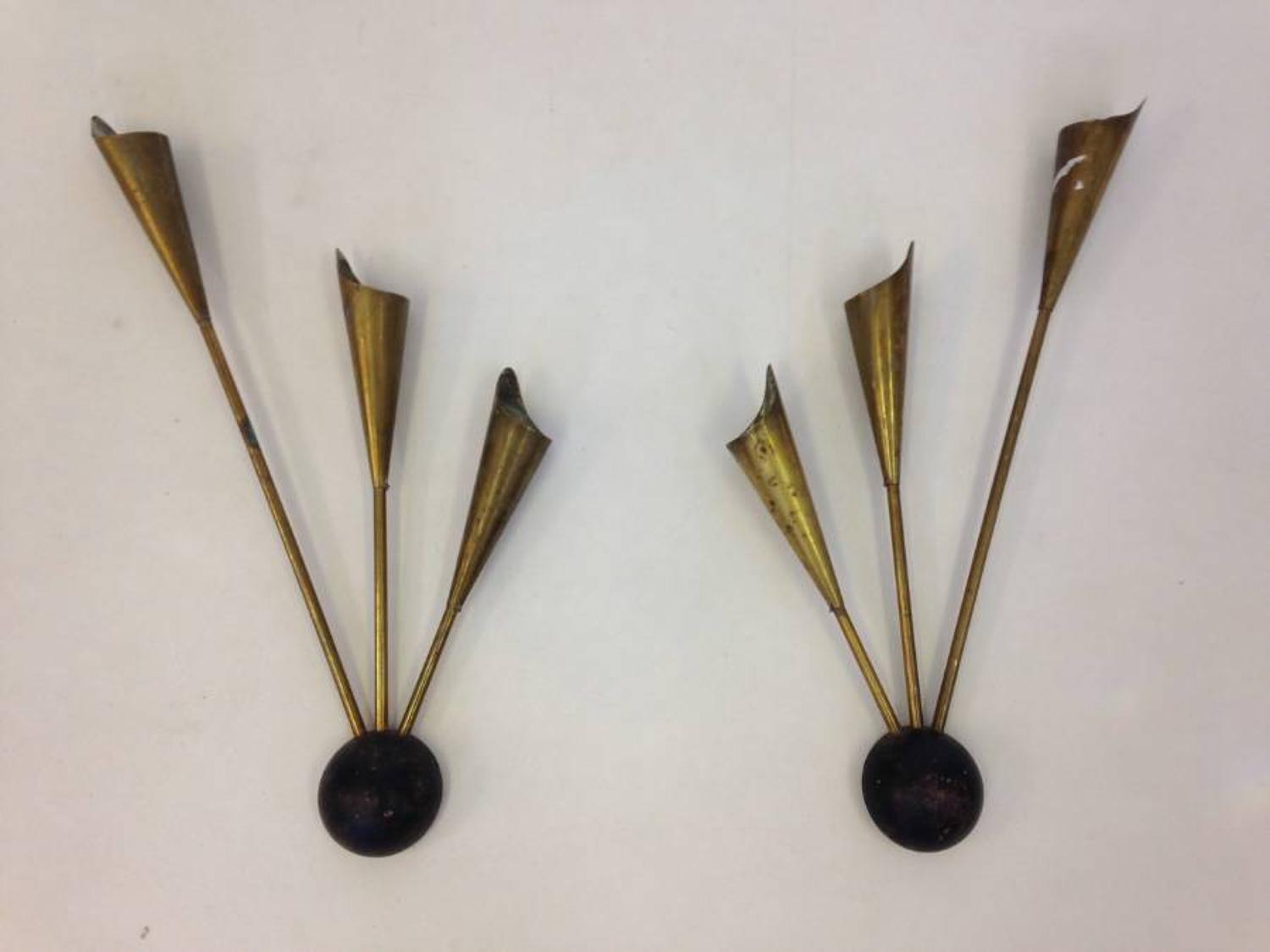 A pair of iron and brass wall sconces