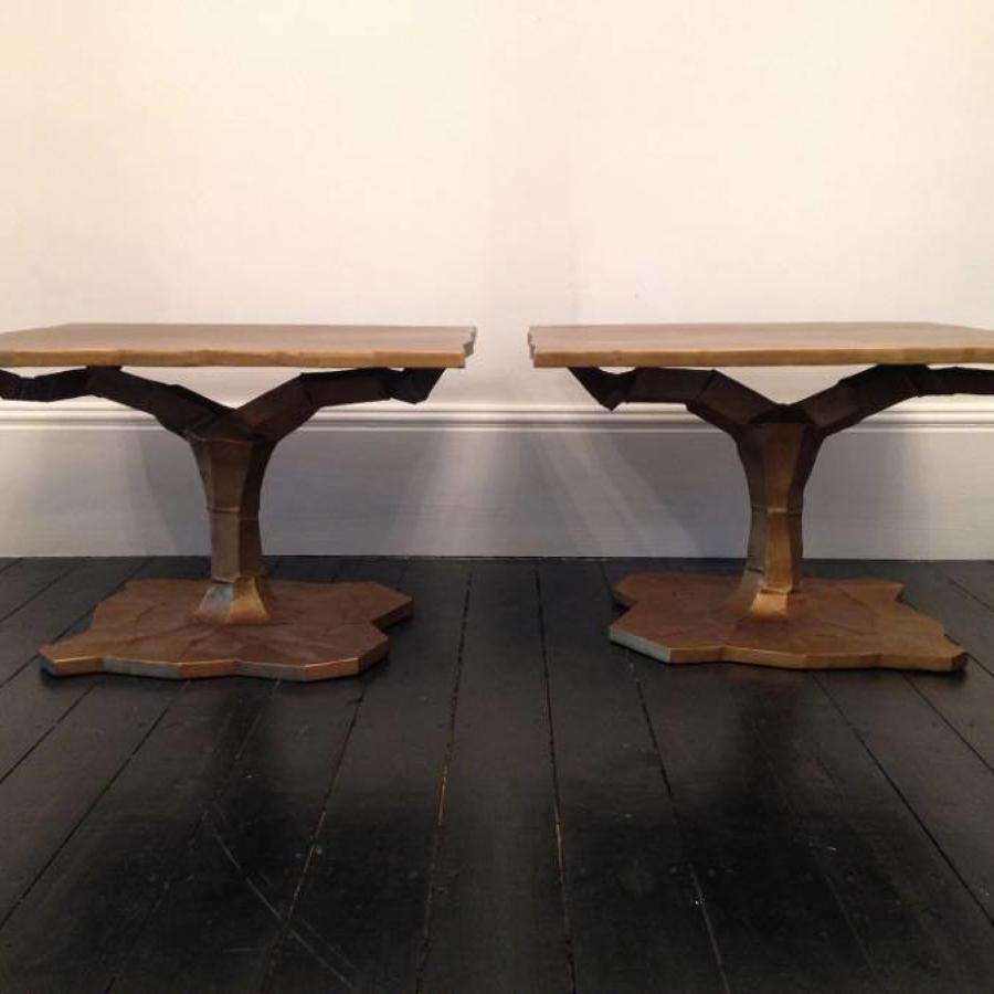 A pair of gold metal side tables