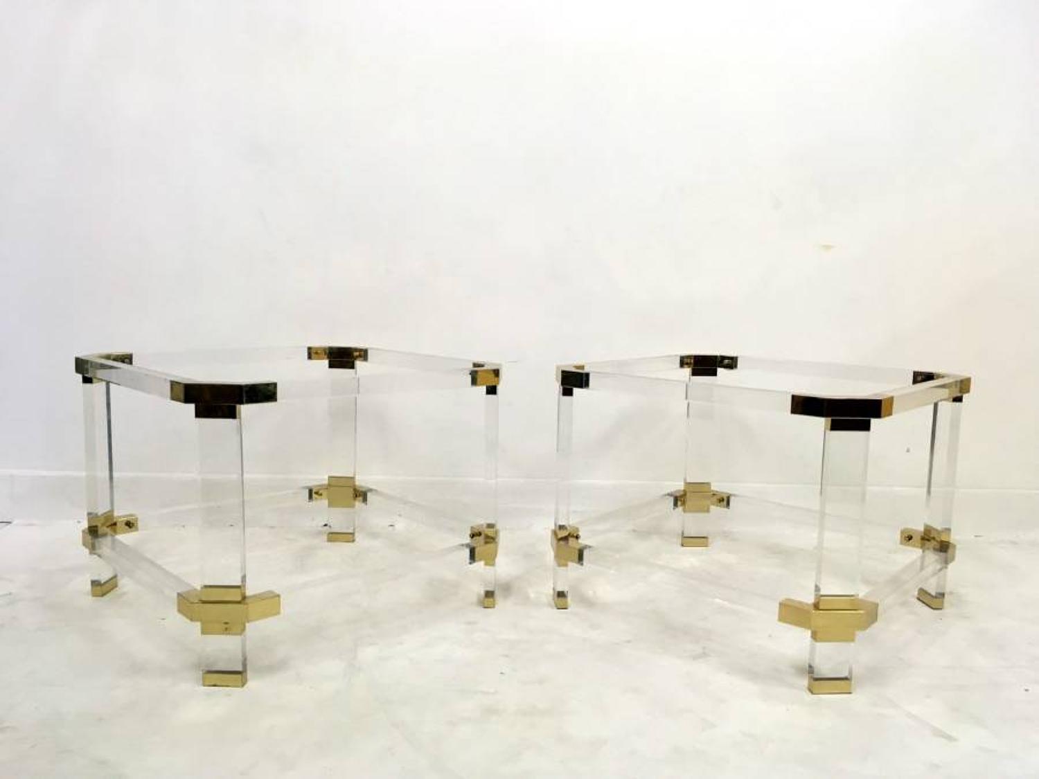 A pair of lucite and brass side tables