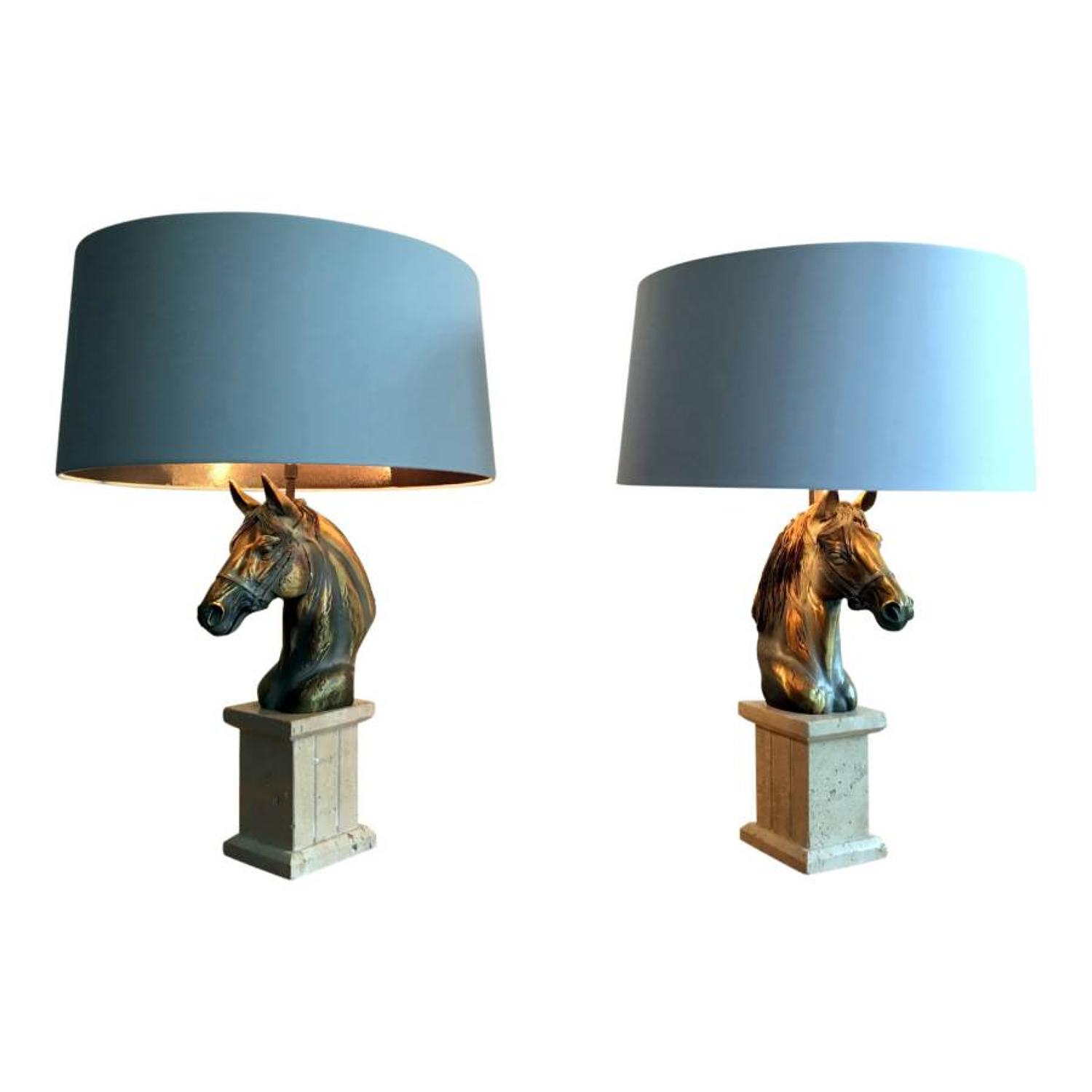 A pair of brass and travertine horse lamps