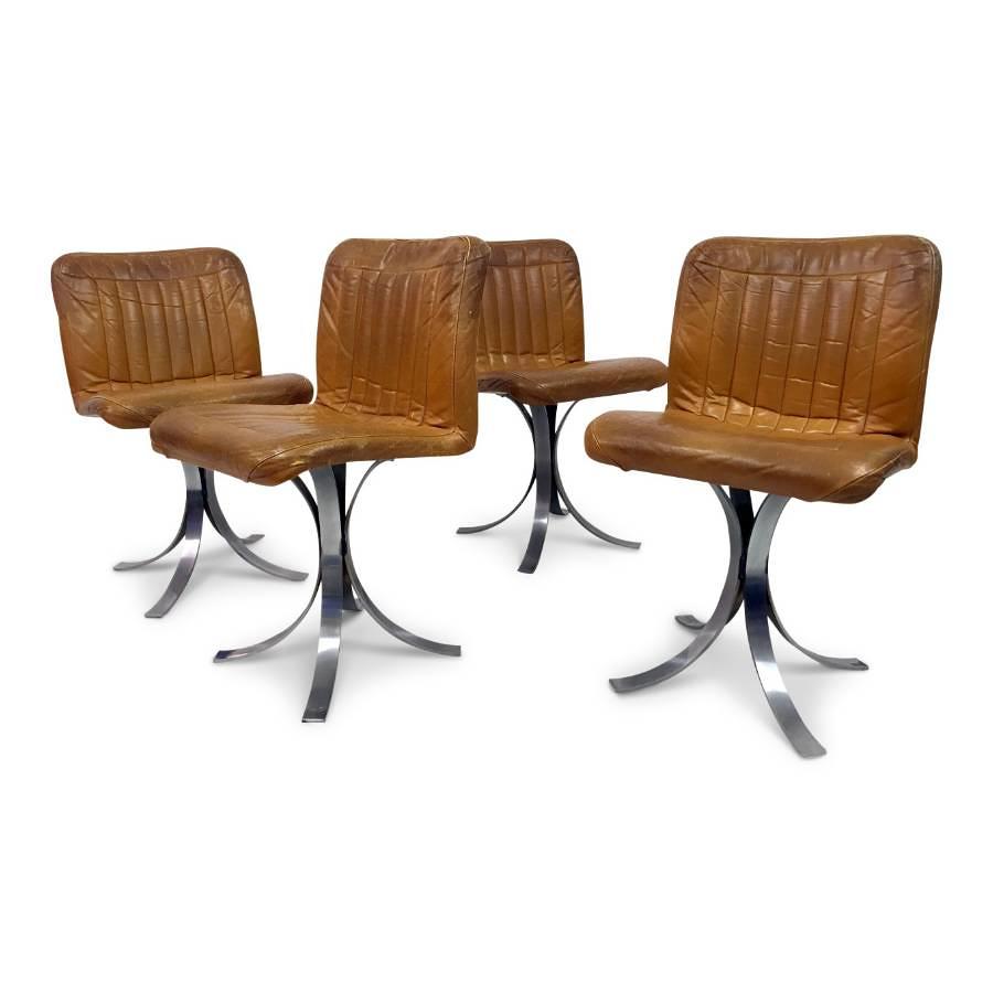 A set of four French leather and chrome dining chairs