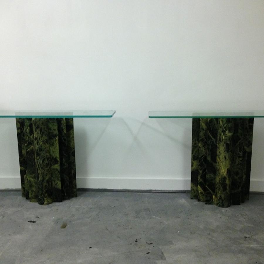 A pair of marble and glass console tables