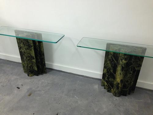 A pair of marble and glass console tables