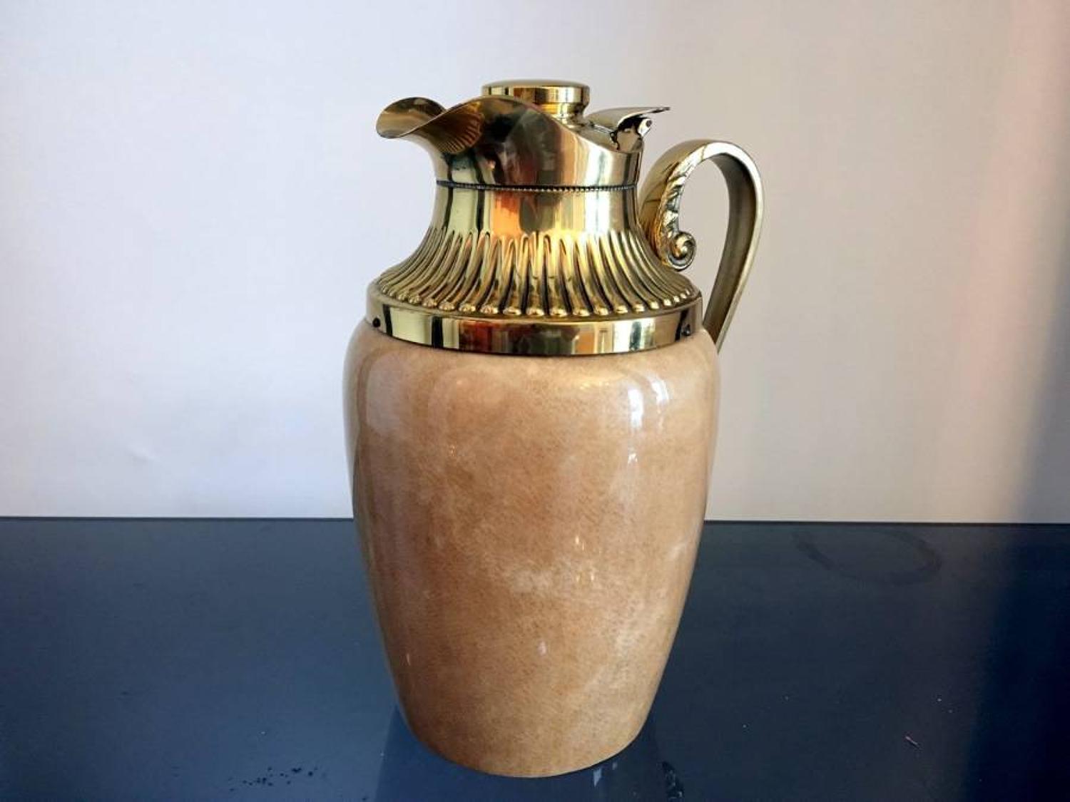 A lacquered goatskin and brass jug  by Aldo Tura