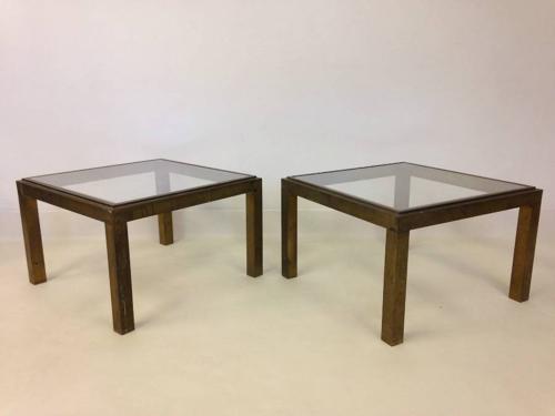 A pair of brass side tables