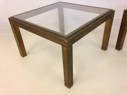 A pair of brass side tables