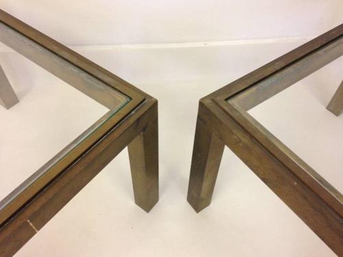 A pair of brass side tables