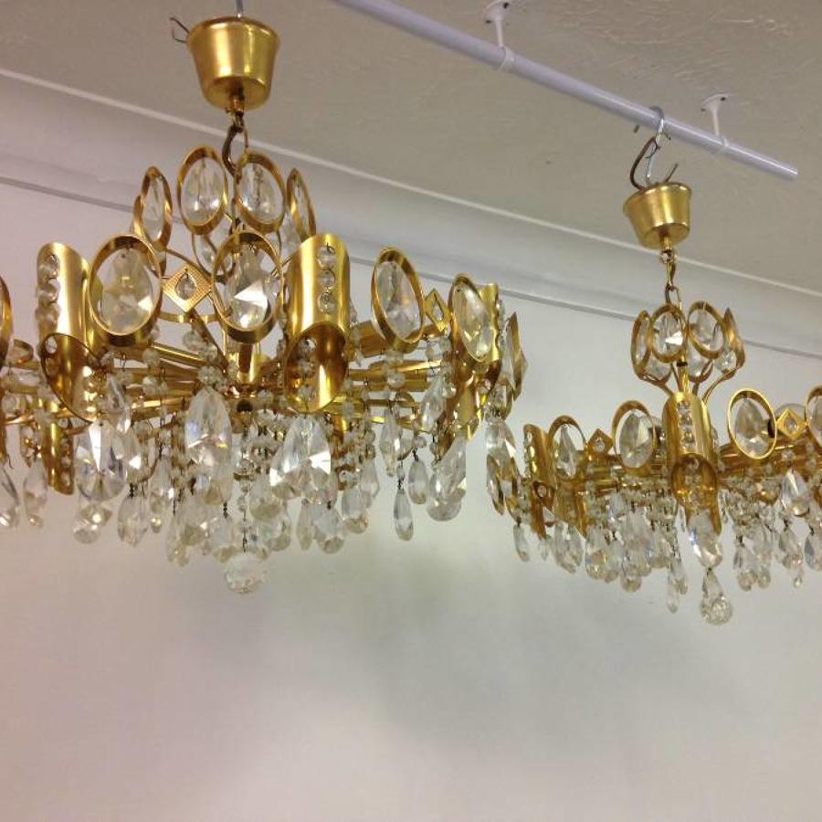 A pair of gilt brass and crystal chandeliers