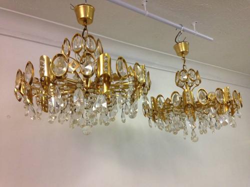 A pair of gilt brass and crystal chandeliers