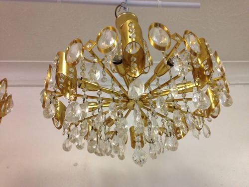 A pair of gilt brass and crystal chandeliers