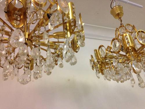 A pair of gilt brass and crystal chandeliers