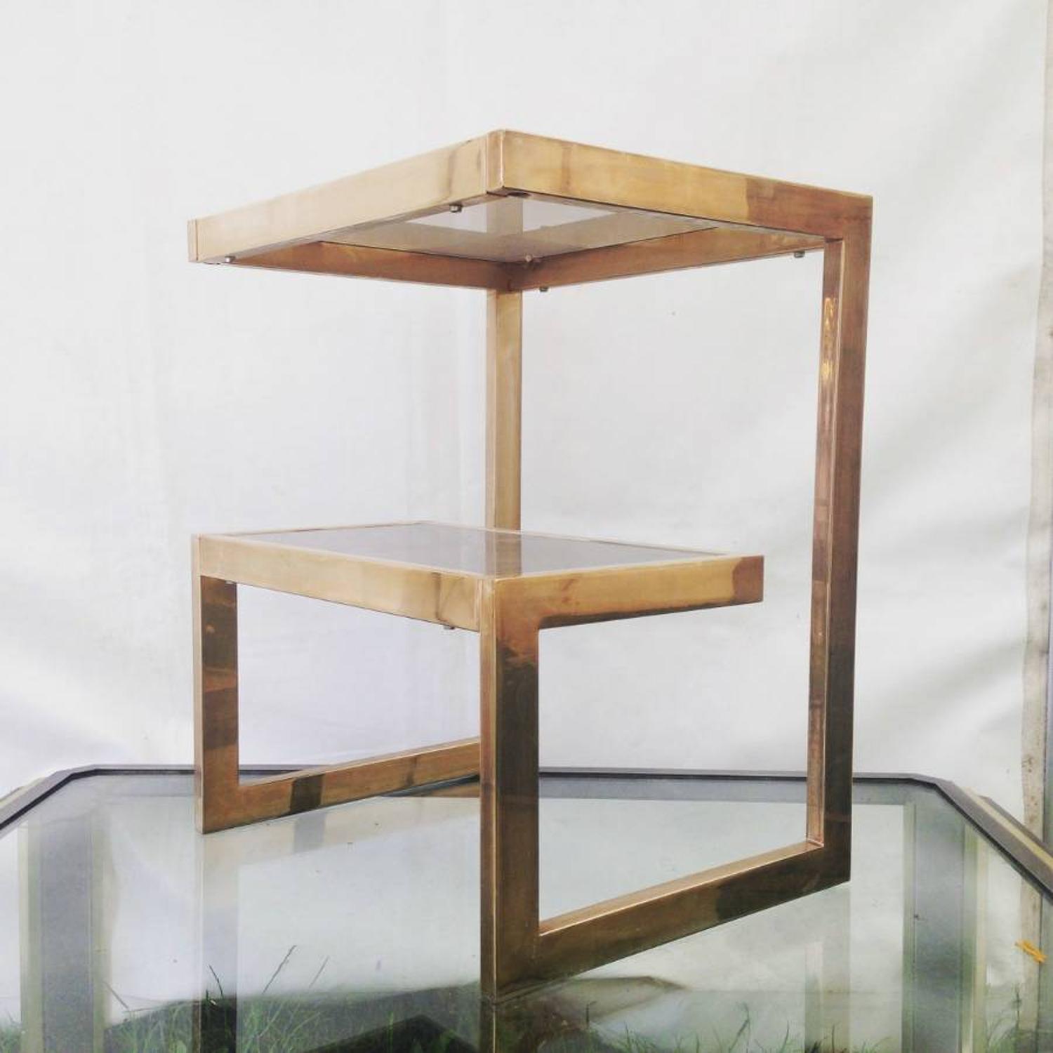 A pair of gold plated G side tables