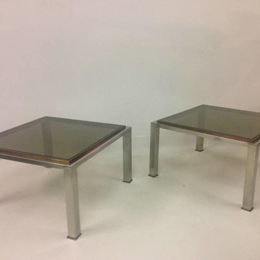 A pair of chrome and brass side tables