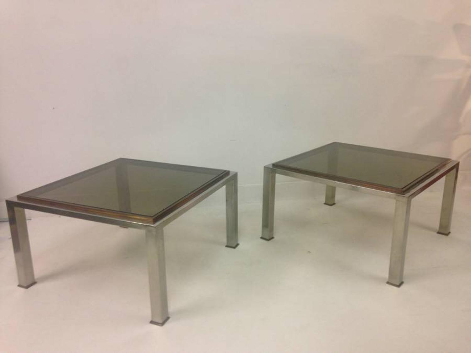 A pair of chrome and brass side tables