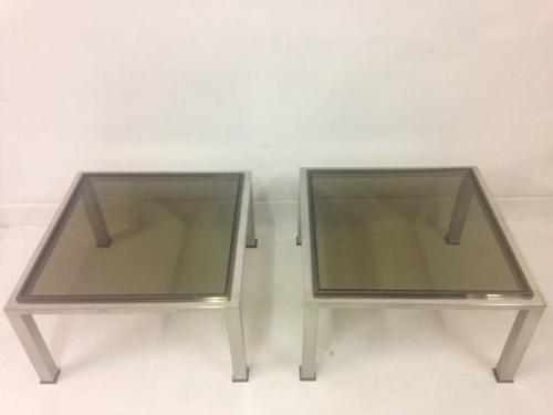 A pair of chrome and brass side tables