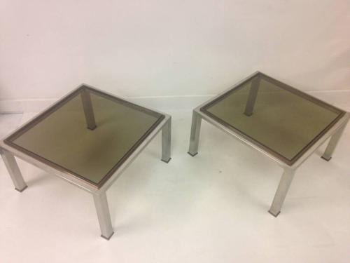 A pair of chrome and brass side tables