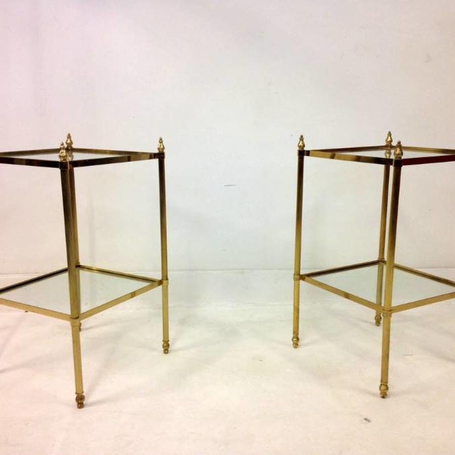 A pair of brass and glass side tables