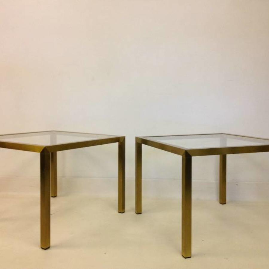 A pair of brushed brass side tables