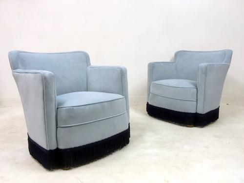 A pair of early 20th Century lounge chairs in blue velvet